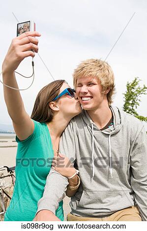 Teenage couple with digital camera View Large Photo Image Stock Image - Teenage couple with digital camera. Fotosearch
