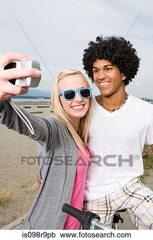 Stock Image - Teenage couple with digital camera. Fotosearch