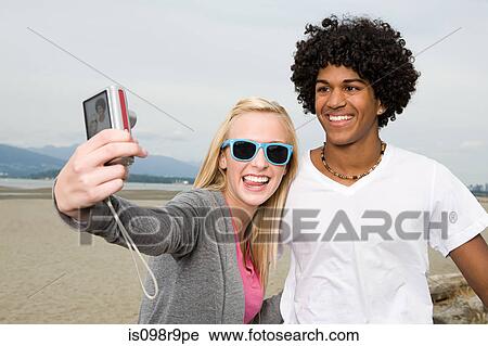 Stock Image - Teenage couple with digital camera. Fotosearch