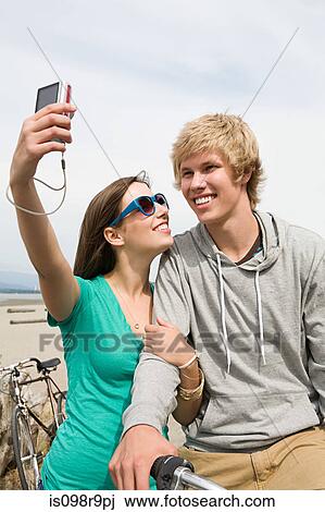 Teenage couple with digital camera View Large Photo Image Stock Image - Teenage couple with digital camera. Fotosearch