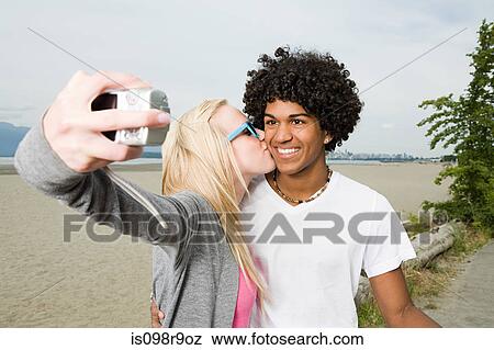 Teenage couple with digital camera View Large Photo Image Stock Photo - Teenage couple with digital camera. Fotosearch