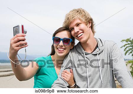 Teenage couple with digital camera View Large Photo Image Stock Photo - Teenage couple with digital camera. Fotosearch