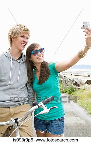 Teenage couple with digital camera View Large Photo Image Stock Photograph - Teenage couple with digital camera. Fotosearch