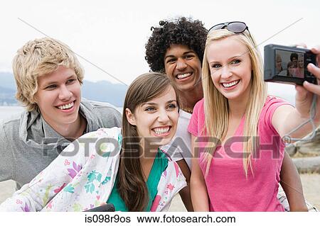 Teenage friends with digital camera View Large Photo Image Stock Photograph - Teenage friends with digital camera. Fotosearch