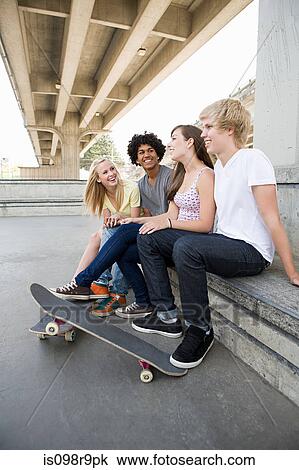 Teenage friends with skateboards View Large Photo Image Stock Image - Teenage friends with skateboards. Fotosearch