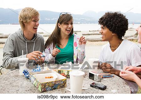 Stock Image - Teenagers with fast food. Fotosearch