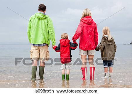 Family holding hands in the sea View Large Photo Image Stock Image - Family holding hands in the sea. Fotosearch