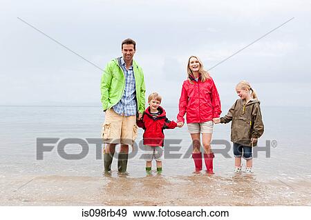 Family holding hands in the sea View Large Photo Image Stock Photo - Family holding hands in the sea. Fotosearch