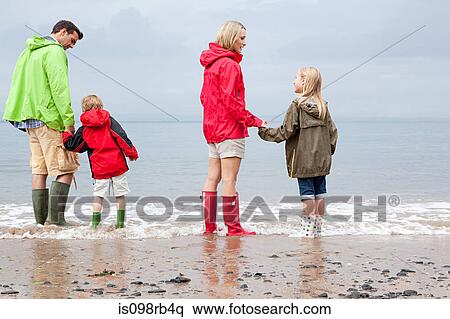 Family standing in the sea View Large Photo Image Stock Photography - Family standing in the sea. Fotosearch