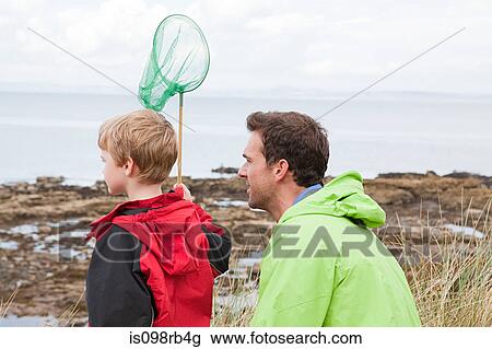 Father and son with fishing net View Large Photo Image Stock Image - Father and son with fishing net. Fotosearch
