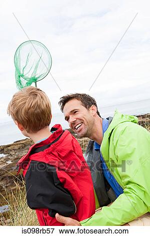 Father and son with fishing net View Large Photo Image Stock Photo - Father and son with fishing net. Fotosearch