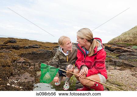 Mother and daughter by rock pools View Large Photo Image Stock Photograph - Mother and daughter by rock pools. Fotosearch