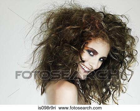 Stock Image - Young woman with curly hair. Fotosearch