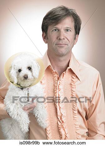 Stock Image - Man with pet poodle. Fotosearch