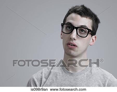 Young man wearing glasses View Large Photo Image Picture - Young man wearing glasses. Fotosearch