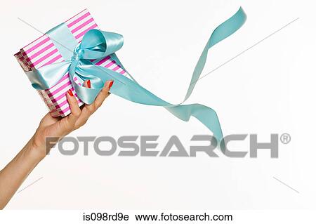 Female hand holding a gift View Large Photo Image Stock Image - Female hand holding a gift. Fotosearch