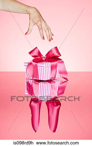 Female hand reaching for gift View Large Photo Image Stock Image - Female hand reaching for gift. Fotosearch