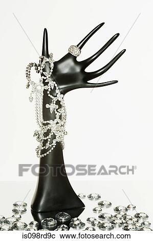 Jewelry on hand shaped stand View Large Photo Image Stock Image - Jewelry on hand shaped stand. Fotosearch