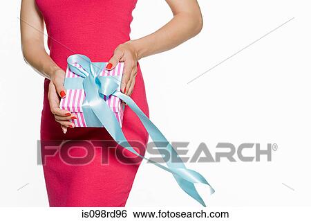 Woman holding a gift View Large Photo Image Stock Photograph - Woman holding a gift. Fotosearch