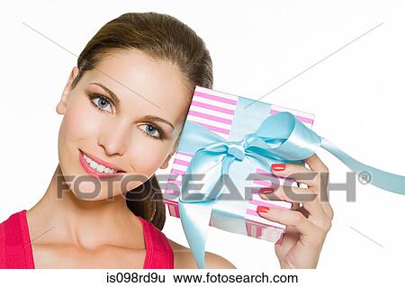 Woman holding a gift View Large Photo Image Stock Photograph - Woman holding a gift. Fotosearch