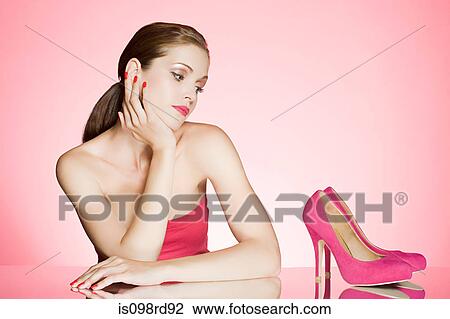 Woman looking at pair of shoes View Large Photo Image Stock Image - Woman looking at pair of shoes. Fotosearch
