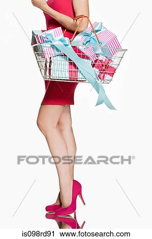 Woman with shopping basket full of gifts View Large Photo Image Stock Image - Woman with shopping basket full of gifts. Fotosearch