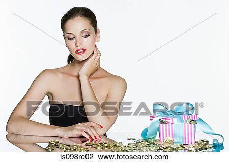 Young woman and gift box of coins View Large Photo Image Stock Image - Young woman and gift box of coins. Fotosearch