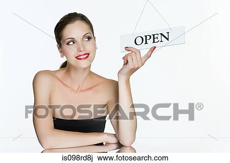Stock Image - Young woman with open sign. Fotosearch