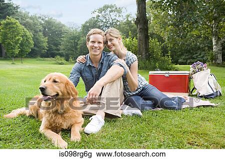 Couple having picnic with their dog View Large Photo Image Stock Image - Couple having picnic with their dog. Fotosearch