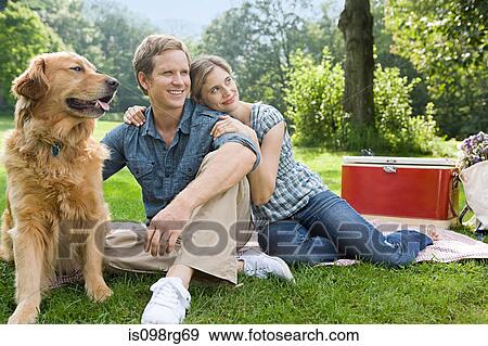 Couple having picnic with their dog View Large Photo Image Stock Photo - Couple having picnic with their dog. Fotosearch