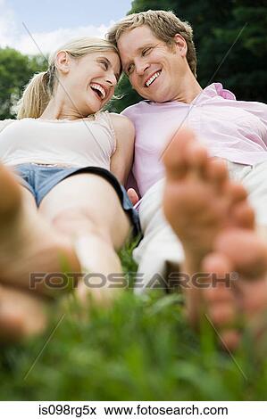 Stock Photo - Couple lying in a field. Fotosearch