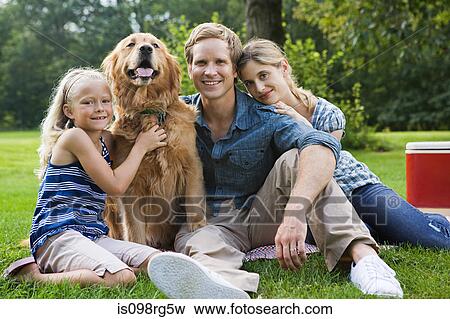 Family in the park with golden retriever View Large Photo Image Stock Photo - Family in the park with golden retriever. Fotosearch
