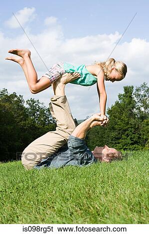 Father and daughter playing in park View Large Photo Image Stock Photograph - Father and daughter playing in park. Fotosearch