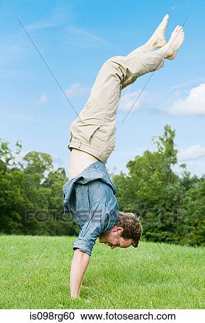 Man doing a handstand View Large Photo Image Stock Image - Man doing a handstand. Fotosearch