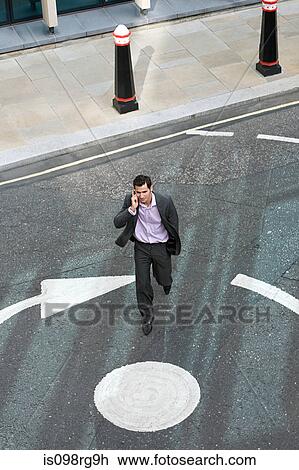 Businessman crossing the street View Large Photo Image Stock Image - Businessman crossing the street. Fotosearch
