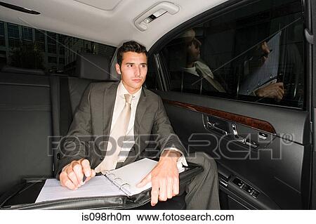Businessman in the back of a car View Large Photo Image Picture - Businessman in the back of a car. Fotosearch