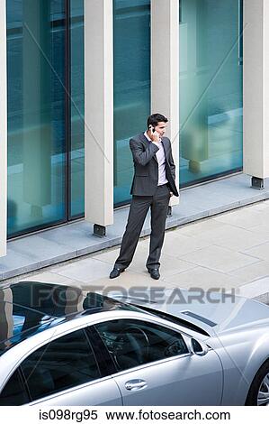Businessman using a cellular telephone View Large Photo Image Stock Photography - Businessman using a cellular telephone. Fotosearch