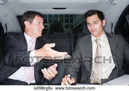 Businessmen talking in car View Large Photo Image Stock Photograph - Businessmen talking in car. Fotosearch