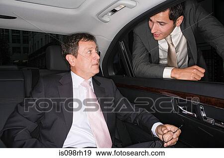 Businessmen talking in the back of a car View Large Photo Image Stock Photo - Businessmen talking in the back of a car. Fotosearch