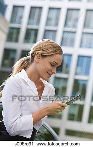 Businesswoman text messaging View Large Photo Image Stock Image - Businesswoman text messaging. Fotosearch
