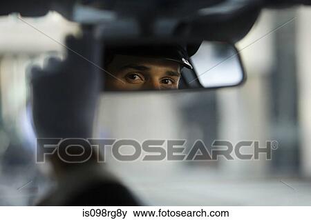 Chauffeur looking in the rear view mirror View Large Photo Image Stock Photo - Chauffeur looking in the rear view mirror. Fotosearch