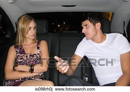 Stock Image - Couple arguing in the back of a car. Fotosearch