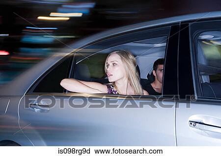 Couple travelling in a speeding car View Large Photo Image Stock Image - Couple travelling in a speeding car. Fotosearch