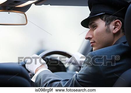 Male chauffeur driving View Large Photo Image Stock Image - Male chauffeur driving. Fotosearch