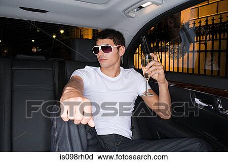 Stylish man in the back of a car View Large Photo Image Stock Image - Stylish man in the back of a car. Fotosearch