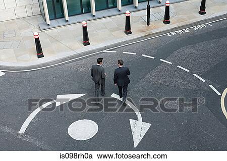 Two businessmen crossing the road View Large Photo Image Stock Image - Two businessmen crossing the road. Fotosearch