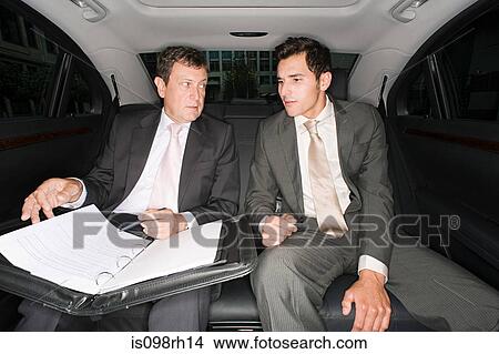 Two businessmen in the back of a car View Large Photo Image Picture - Two businessmen in the back of a car. Fotosearch