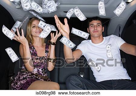 Stock Photo - Wealthy couple celebrating in a car. Fotosearch