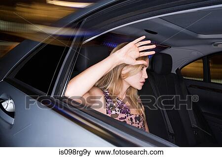 Woman with hand raised to car window View Large Photo Image Stock Photo - Woman with hand raised to car window. Fotosearch