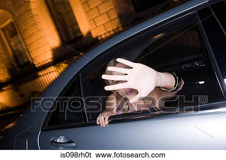 Stock Photograph - Woman with her hand raised to camera. Fotosearch